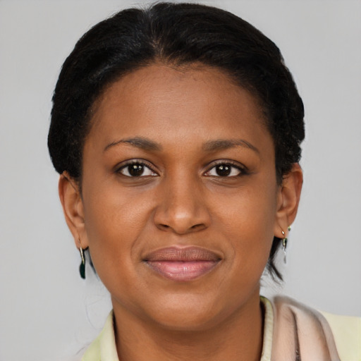 Joyful black young-adult female with short  brown hair and brown eyes