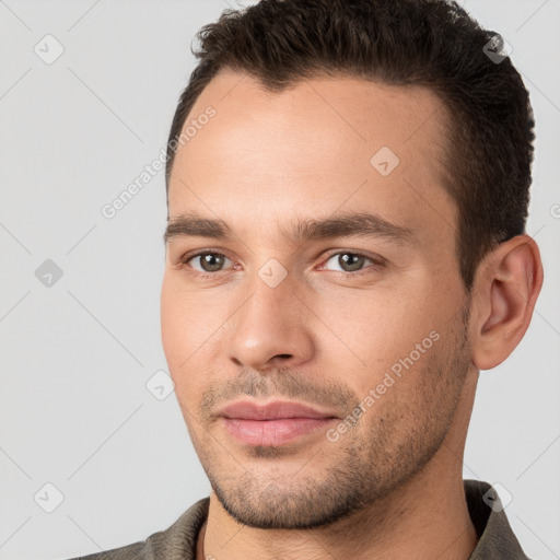 Joyful white young-adult male with short  brown hair and brown eyes