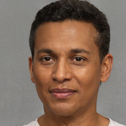 Joyful latino adult male with short  black hair and brown eyes