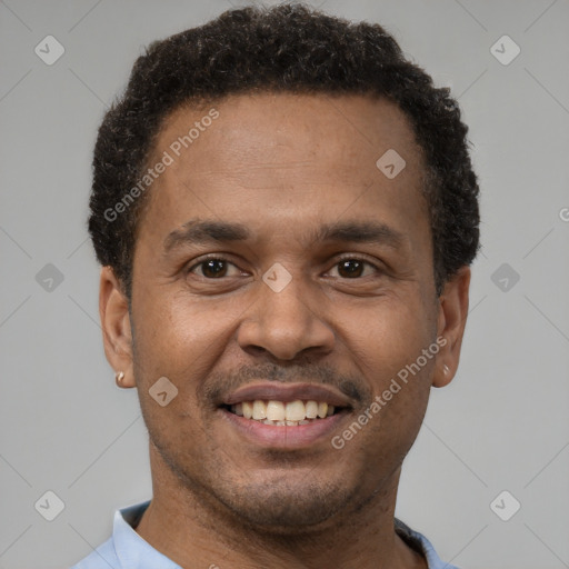 Joyful latino young-adult male with short  brown hair and brown eyes