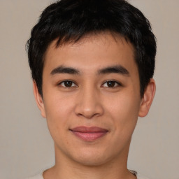 Joyful asian young-adult male with short  brown hair and brown eyes