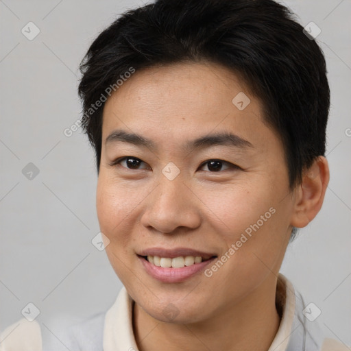 Joyful asian young-adult female with short  brown hair and brown eyes