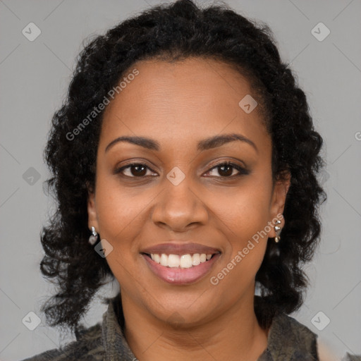 Joyful black young-adult female with long  brown hair and brown eyes