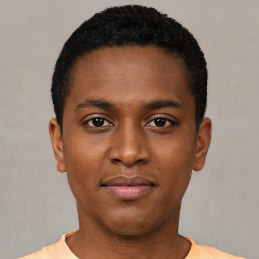 Joyful black young-adult male with short  black hair and brown eyes