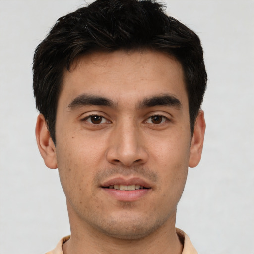 Joyful white young-adult male with short  black hair and brown eyes