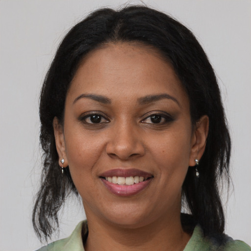 Joyful black young-adult female with medium  brown hair and brown eyes