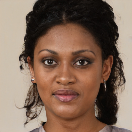 Joyful black young-adult female with medium  black hair and brown eyes