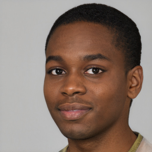 Joyful black young-adult male with short  brown hair and brown eyes