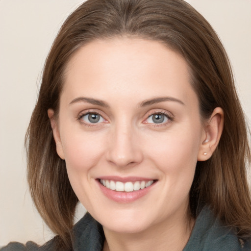 Joyful white young-adult female with long  brown hair and grey eyes