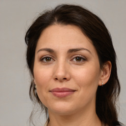 Joyful white adult female with medium  brown hair and brown eyes