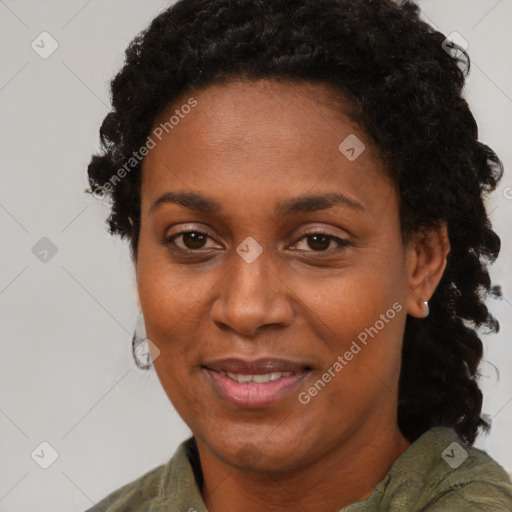 Joyful black adult female with short  black hair and brown eyes