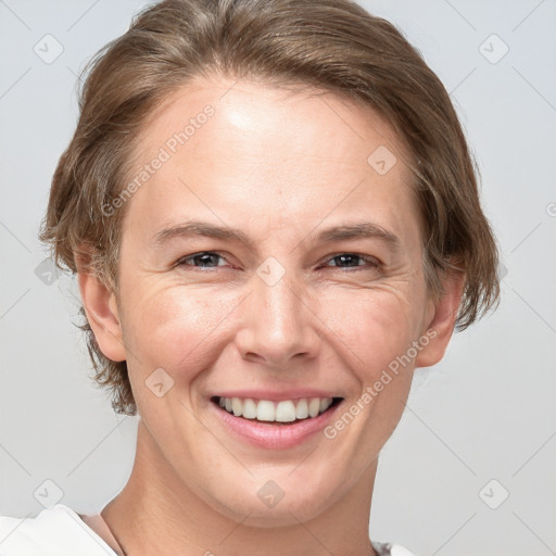 Joyful white adult female with short  brown hair and grey eyes