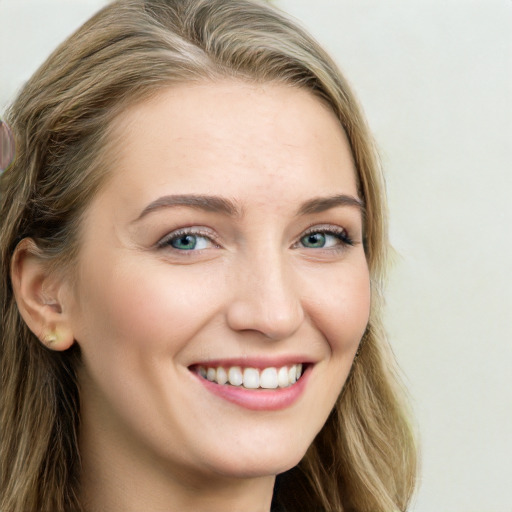 Joyful white young-adult female with long  brown hair and green eyes