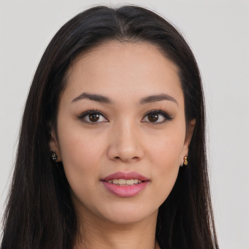 Joyful asian young-adult female with long  brown hair and brown eyes