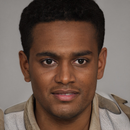 Joyful black young-adult male with short  brown hair and brown eyes