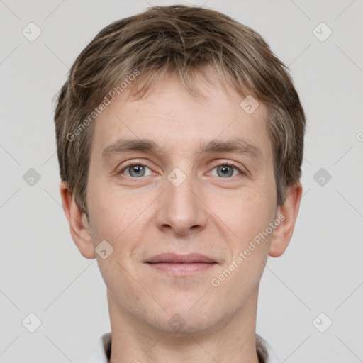 Joyful white young-adult male with short  brown hair and grey eyes