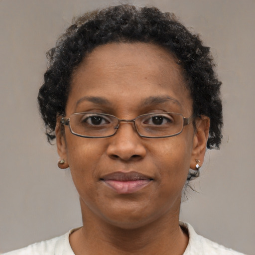 Joyful black adult female with short  brown hair and brown eyes