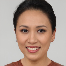 Joyful asian young-adult female with short  brown hair and brown eyes