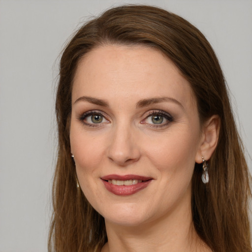 Joyful white young-adult female with long  brown hair and grey eyes