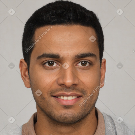 Joyful latino young-adult male with short  brown hair and brown eyes