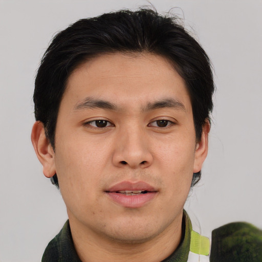 Joyful asian young-adult male with short  brown hair and brown eyes