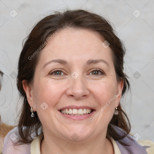 Joyful white adult female with medium  brown hair and blue eyes