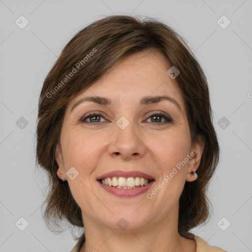 Joyful white adult female with medium  brown hair and grey eyes