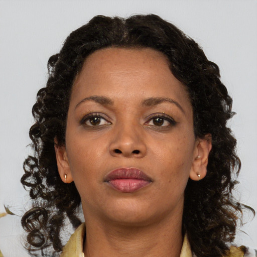 Neutral black adult female with medium  brown hair and brown eyes