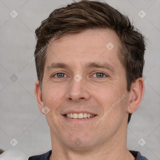 Joyful white adult male with short  brown hair and grey eyes