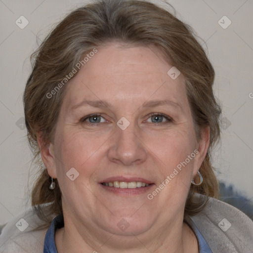 Joyful white adult female with medium  brown hair and blue eyes