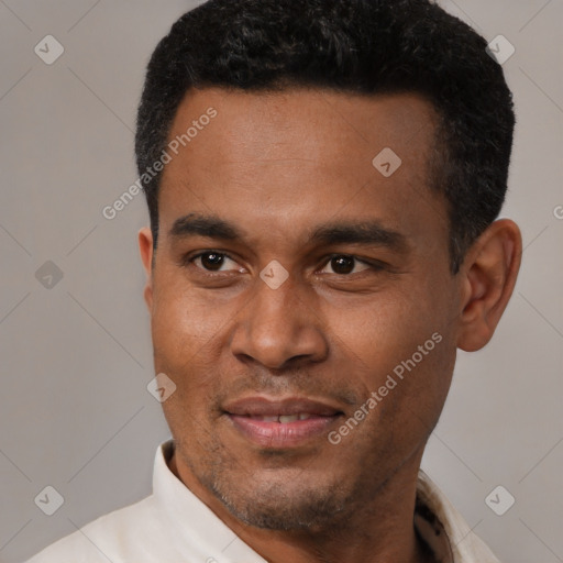 Joyful latino adult male with short  black hair and brown eyes