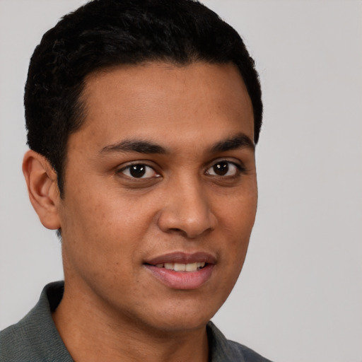 Joyful latino young-adult male with short  brown hair and brown eyes