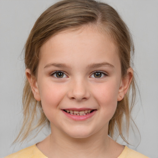 Joyful white child female with medium  brown hair and brown eyes