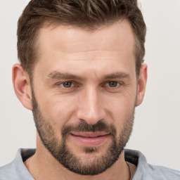 Joyful white adult male with short  brown hair and brown eyes