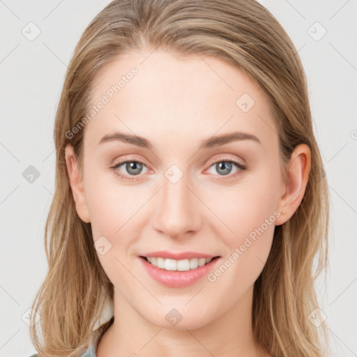 Joyful white young-adult female with long  brown hair and blue eyes