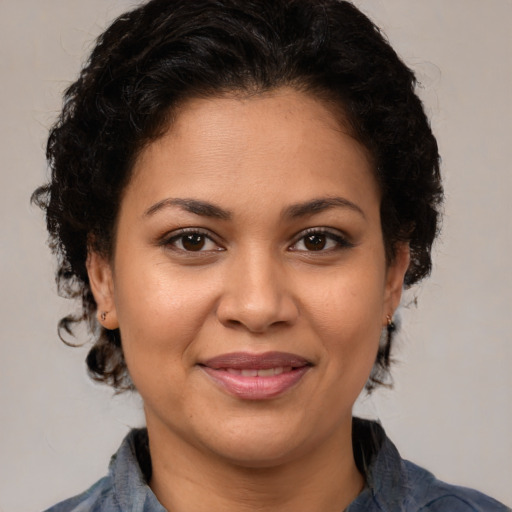 Joyful latino adult female with medium  brown hair and brown eyes