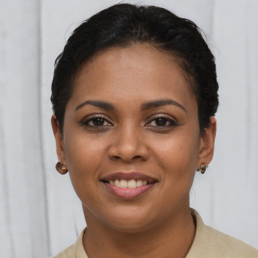 Joyful latino young-adult female with short  brown hair and brown eyes