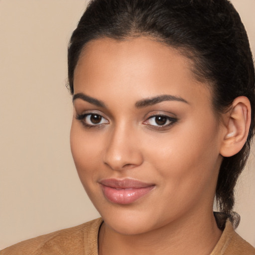 Joyful latino young-adult female with medium  brown hair and brown eyes