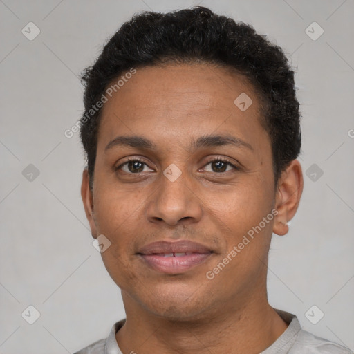 Joyful black young-adult male with short  black hair and brown eyes