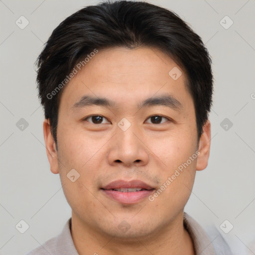 Joyful asian young-adult male with short  brown hair and brown eyes