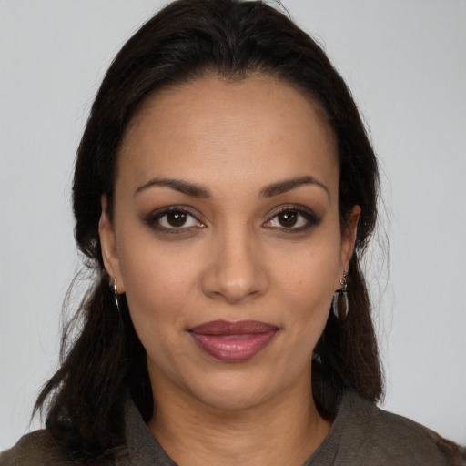 Joyful latino young-adult female with long  brown hair and brown eyes