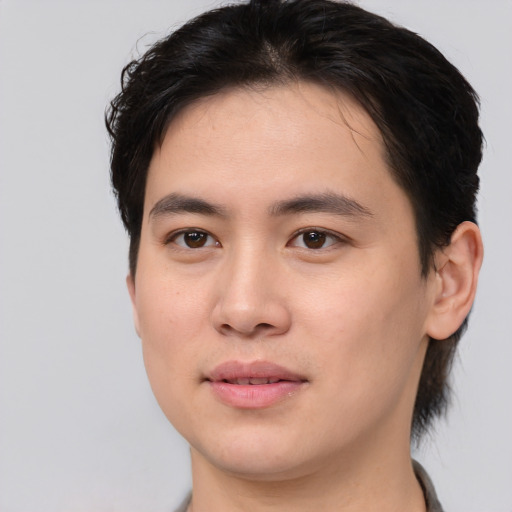 Joyful asian young-adult male with short  brown hair and brown eyes