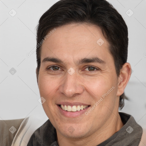 Joyful white adult male with short  brown hair and brown eyes