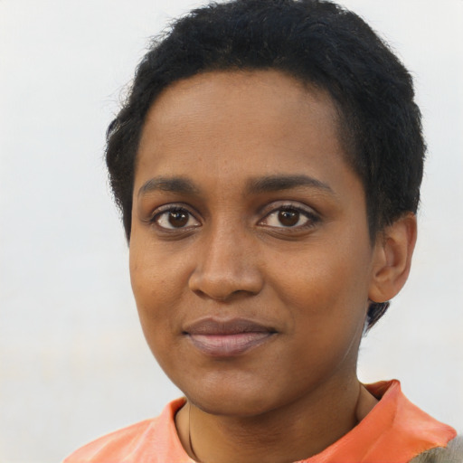 Joyful black young-adult female with short  black hair and brown eyes
