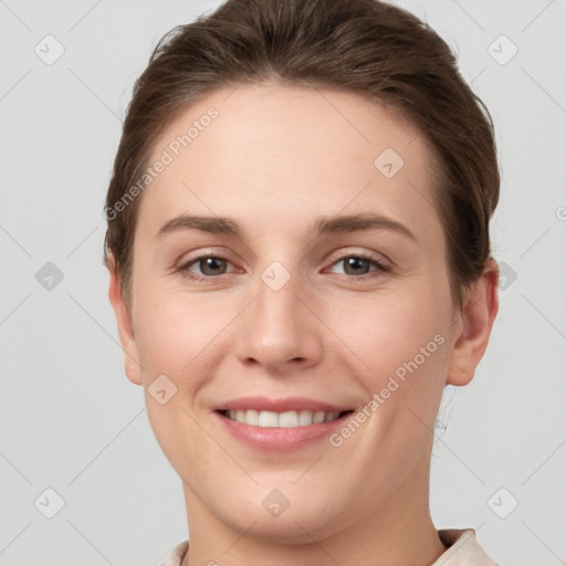 Joyful white young-adult female with short  brown hair and grey eyes