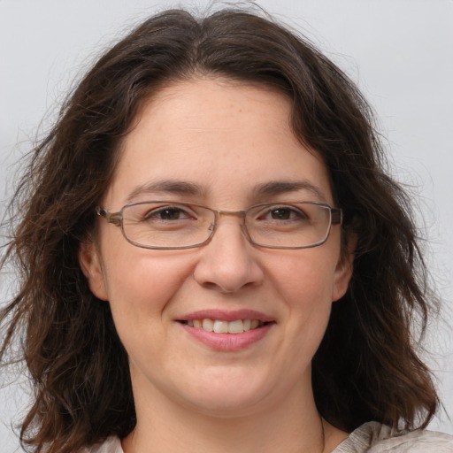 Joyful white adult female with medium  brown hair and brown eyes