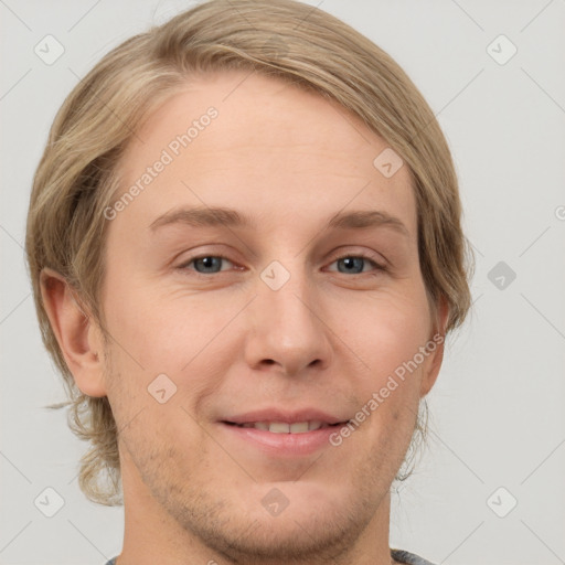 Joyful white young-adult male with medium  brown hair and grey eyes