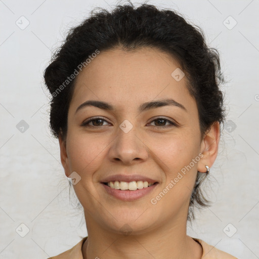 Joyful latino young-adult female with short  brown hair and brown eyes