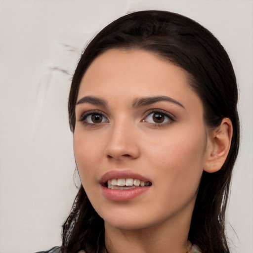 Joyful white young-adult female with long  black hair and brown eyes