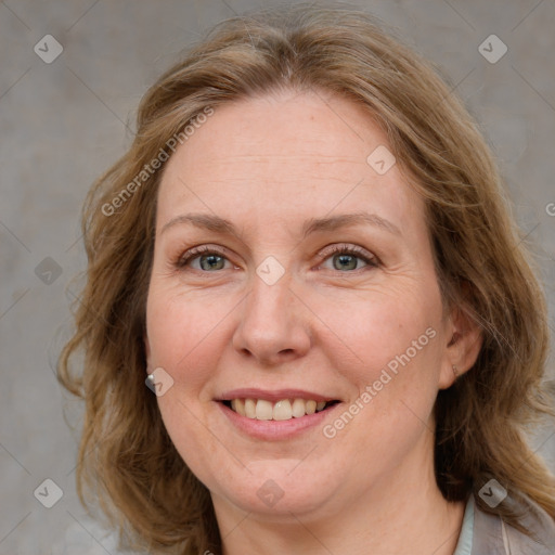 Joyful white adult female with medium  brown hair and blue eyes